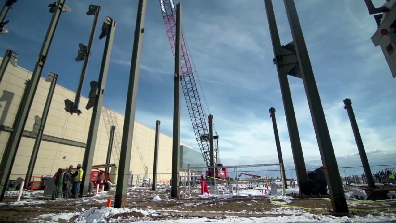 Steel columns going up with a crane on a data center construction site